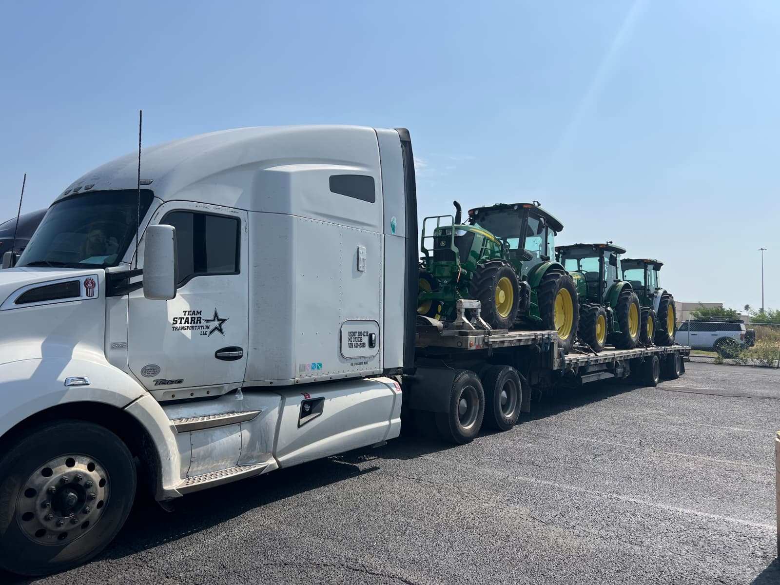 Farm tractors loaded on a step deck