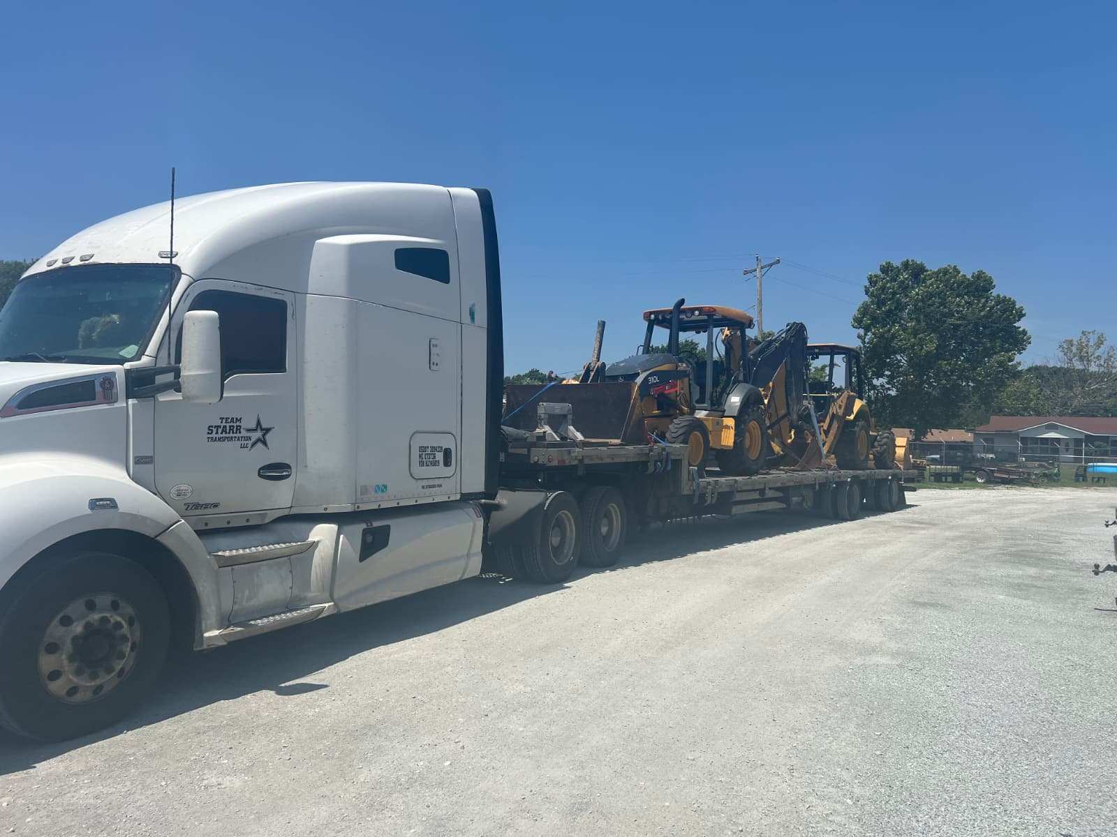 Backhoes loaded on a step deck